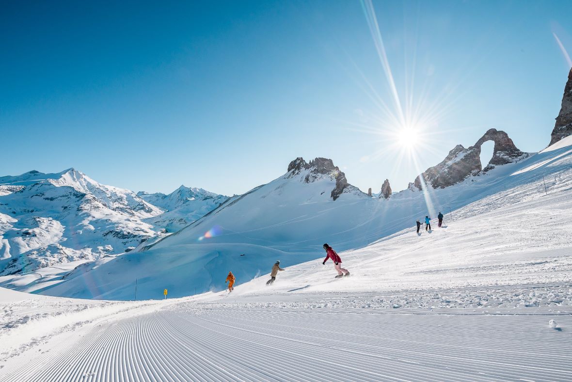 Skiers and snowboarders below the Aiguille Percee in Tignes ski resort